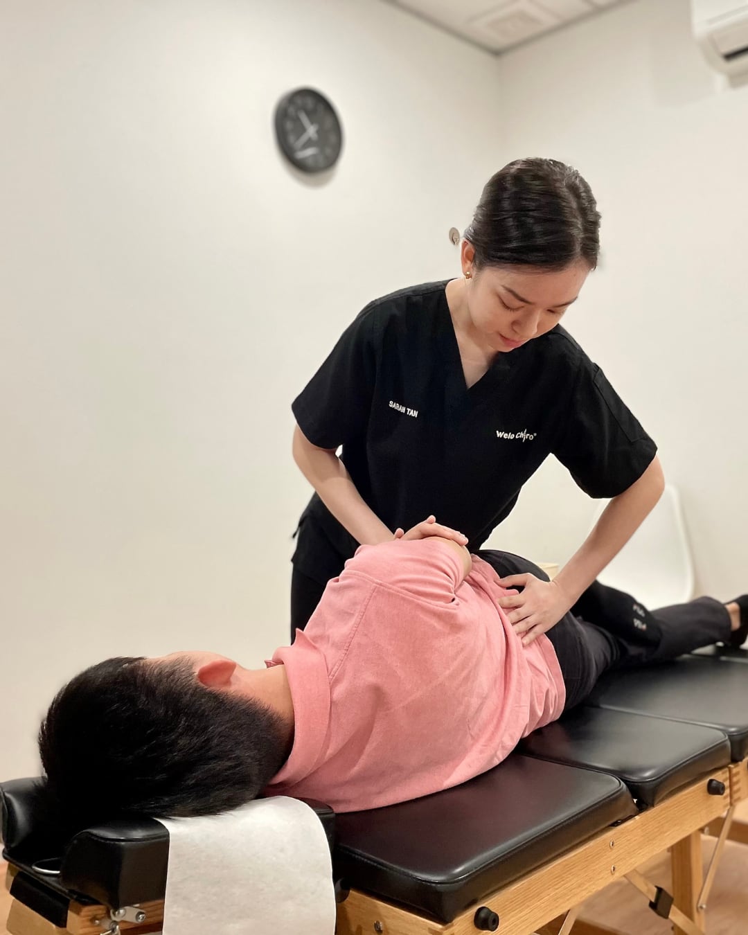 A chiropractor assessing a patient