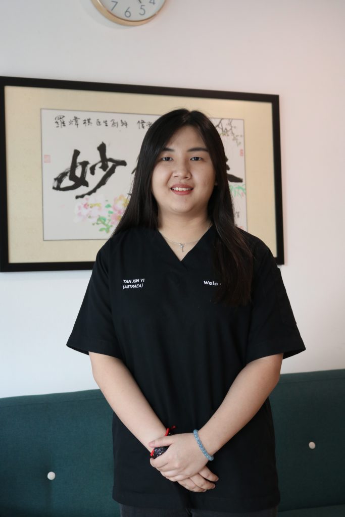 Portrait of Dr Xin Yi in black scrubs