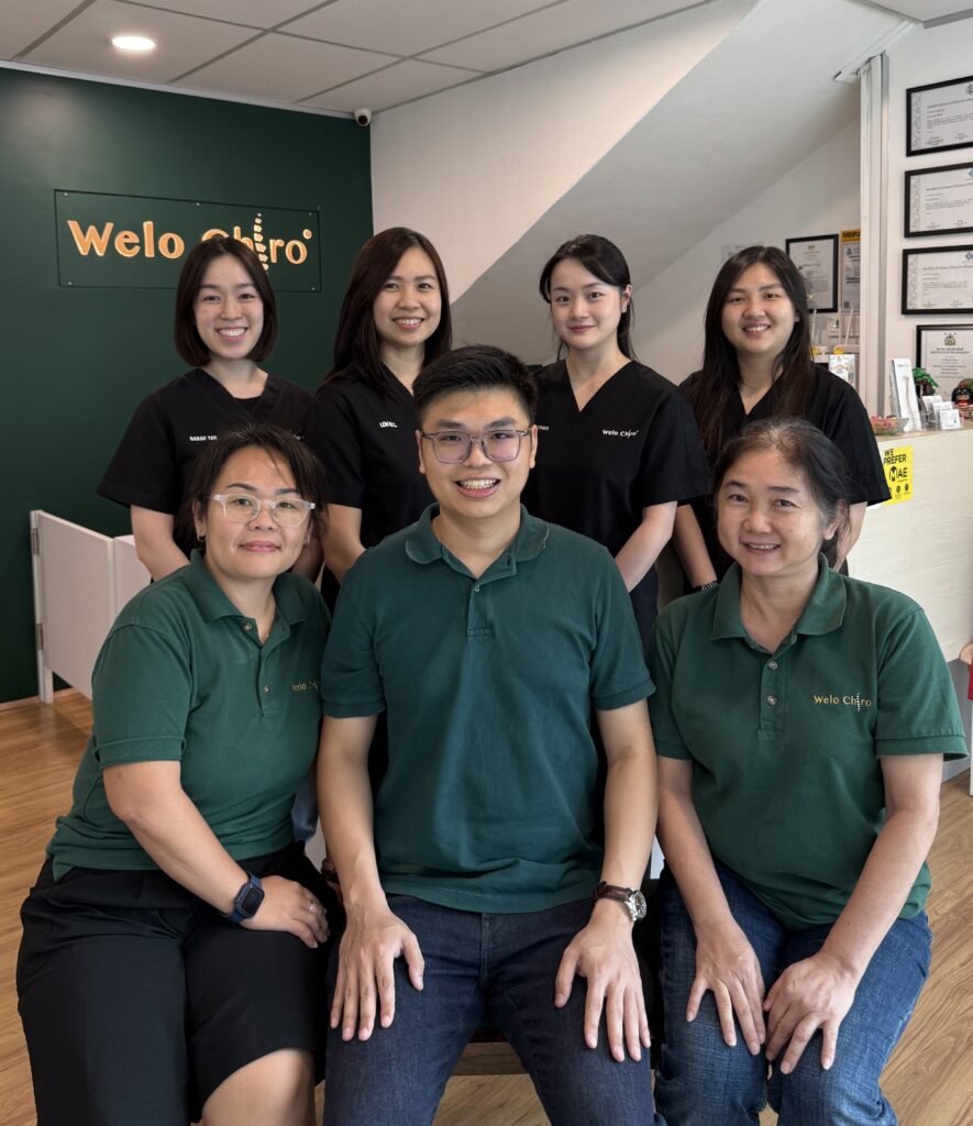 The Welo team in green Welo polos, standing in front of a Welo Chiro backdrop