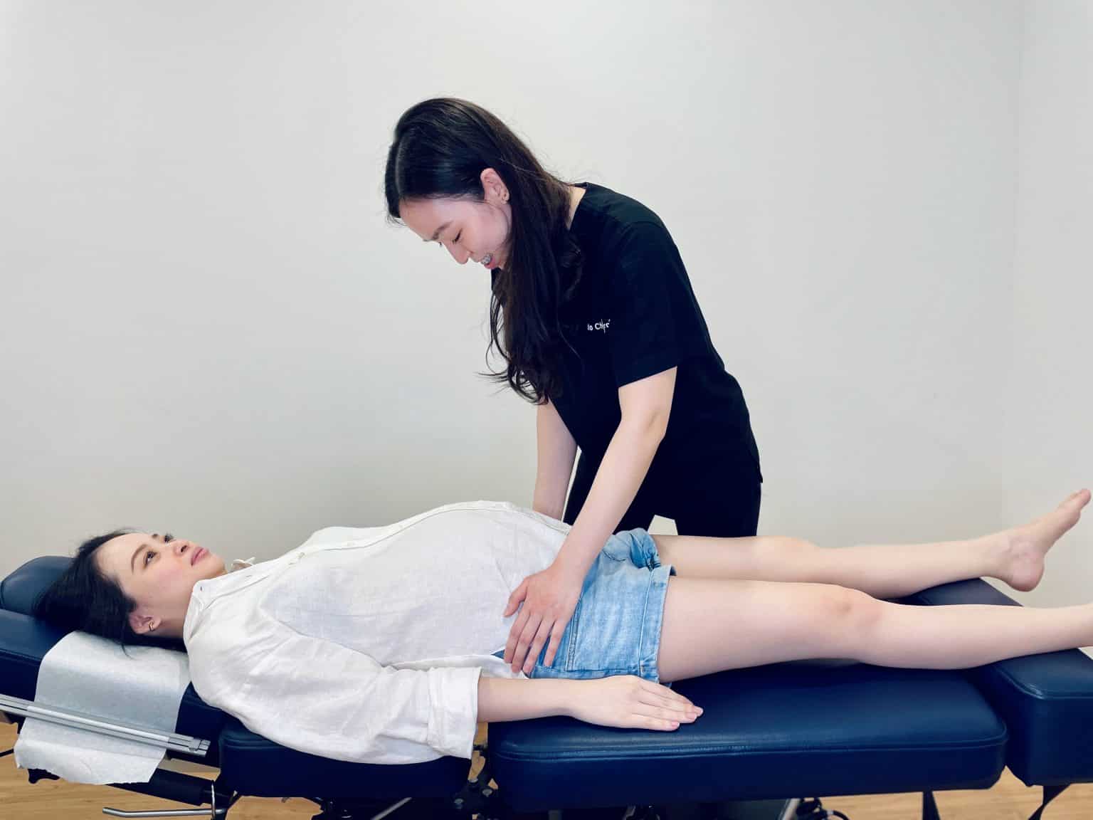 A practitioner giving a side lying Webster technique treatment